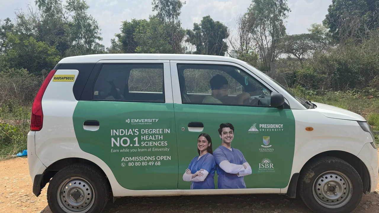 LetzRyd WagonR wrapped in a Presidency University admissions ad