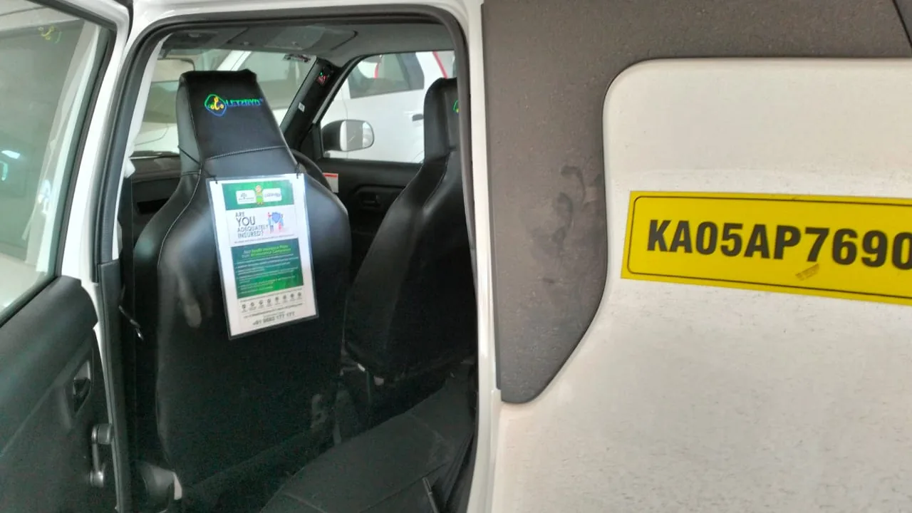 Printed ad card in the seat-back pouch of a LetzRyd WagonR