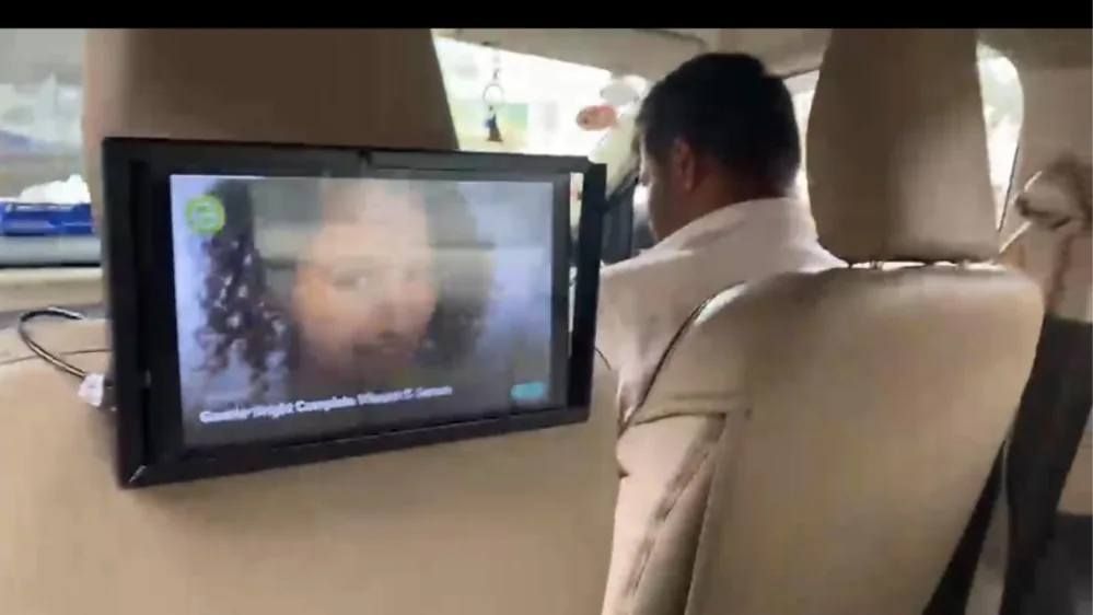 Seat-back tablet playing a video ad for the rear passenger of a LetzRyd car