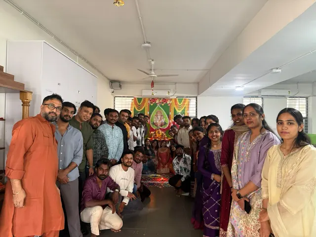 Team group photo in front of the Ganesh idol at the office
