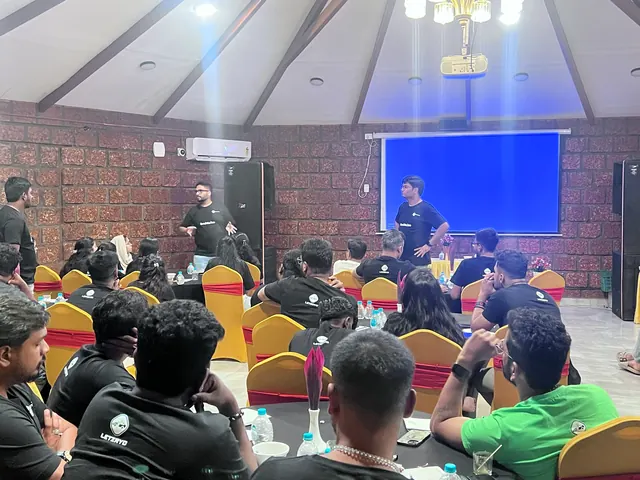 Team members listening to a presentation during a town hall
